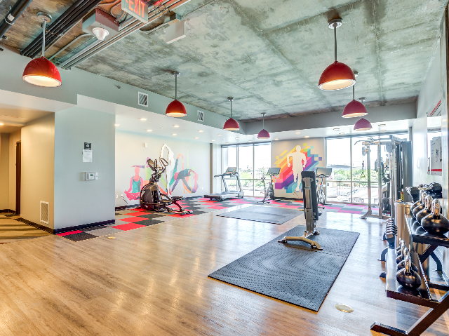 Fitness Center with Panoramic Strip View Including Free Weights and Peloton® Bikes