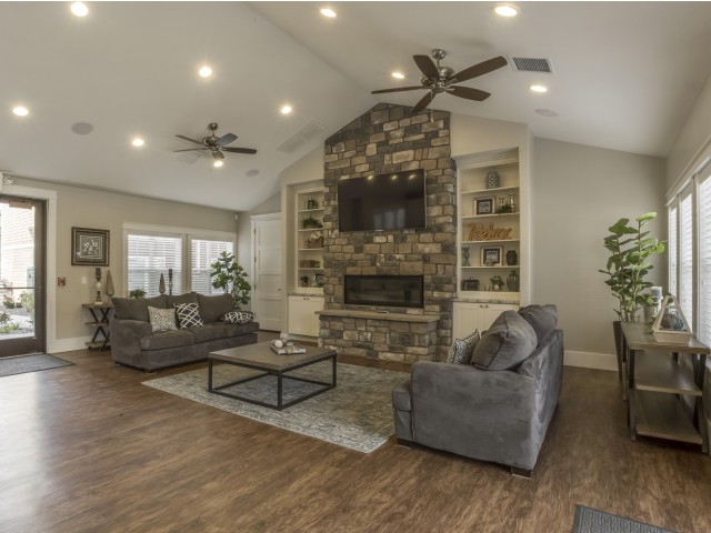 Activity Center with 1 flat screen television, 1 fireplace, 2 couches, coffee table, and open space
