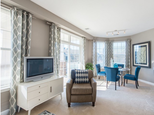 Living room and separate dining area with floor-to-ceiling windows at Prospect Hall Apartments