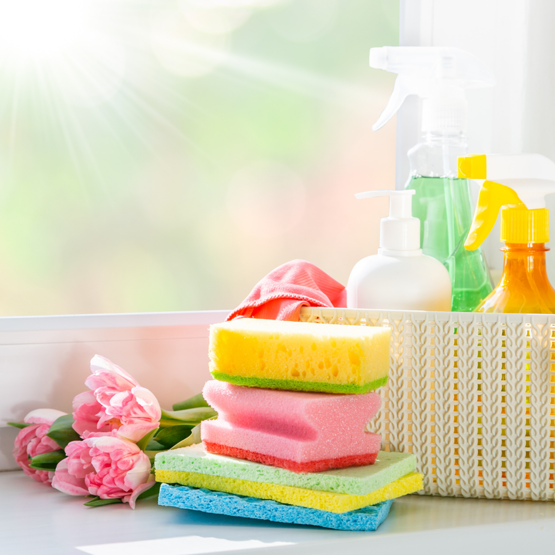 Spring Cleaning Supplies with Pink Roses and Sun Shining Through Window