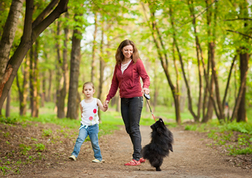 Woman and child walking dog