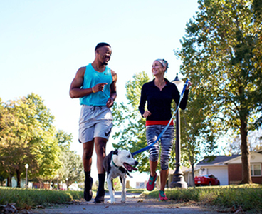 Pet friendly community | Free resident events for all ages | Man and woman running with dog