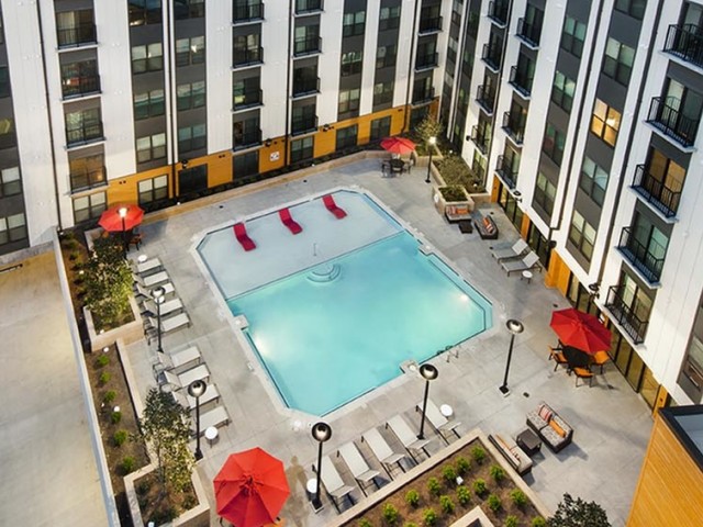 Enjoy Our Pool, With View of Sundeck, Loungers, Picnic Areas, and Outdoor Furniture at Cottonwood Westside Apartments