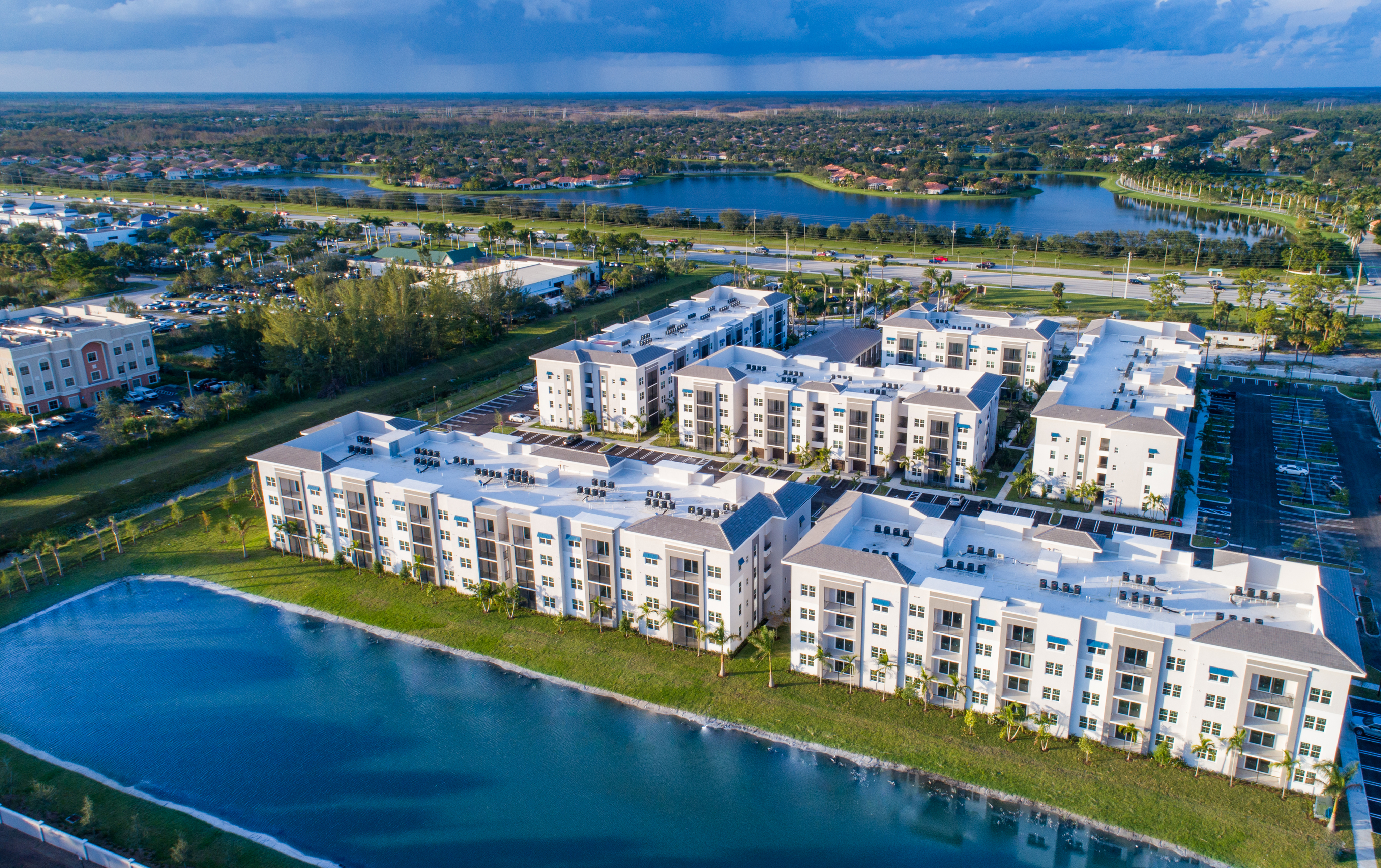 Enjoy Our Pool, Lake and Scenic Views, With View of West Palm Apartments, Lake, and Surroundings at Cottonwood West Palm Apartments