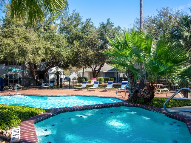 Enjoy Our Hot Tub, With View of Sundeck, Landscaping and Lounge Chairs at Solara Apartments