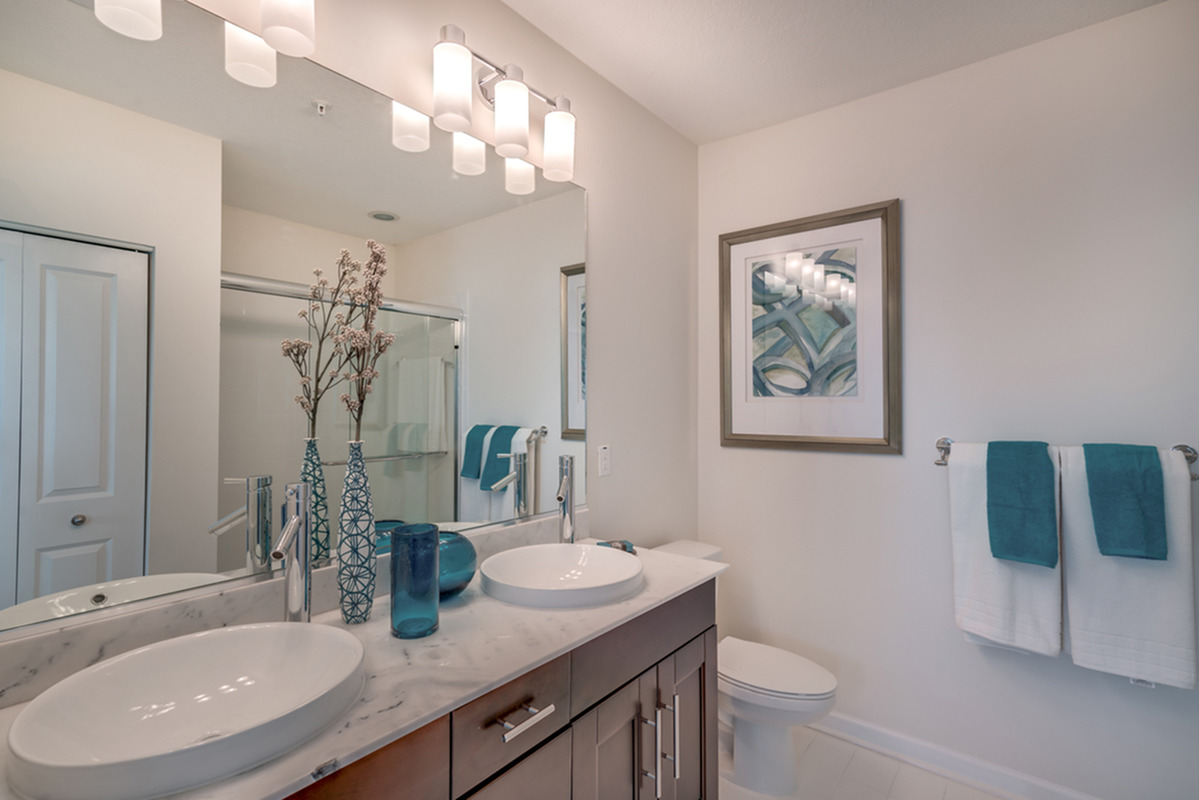 View of Bathroom, Showing Vanity Double Sinks, Toilet, and Walk-In Shower at The Marq Highland Park Apartments