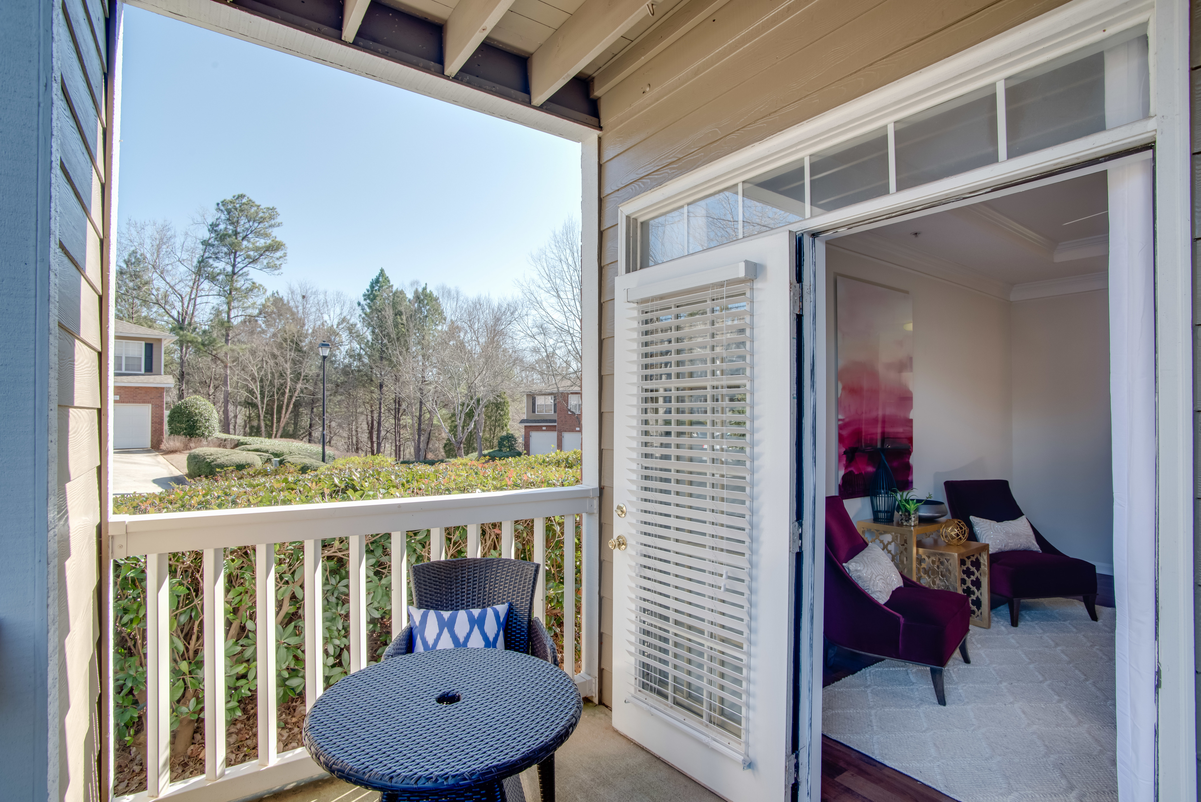 View of Patio, Showing Outdoor Furniture and View of Living Room at Retreat at Peachtree City Apartments