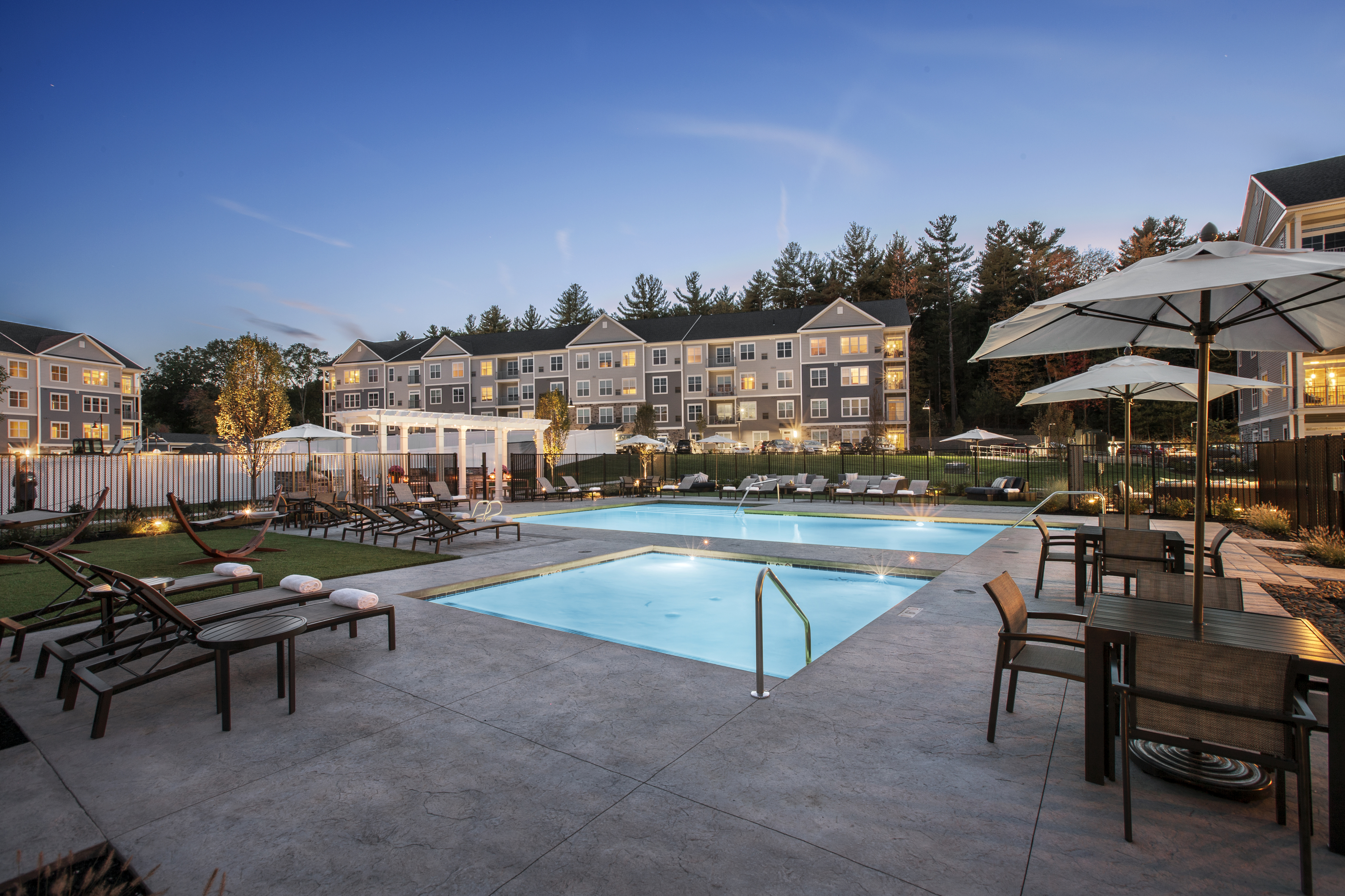 View of Pool Area, Showing Kiddie Pool, Loungers, Pergola, and Apartment Buildings in Background at Parc Westborough Apartments