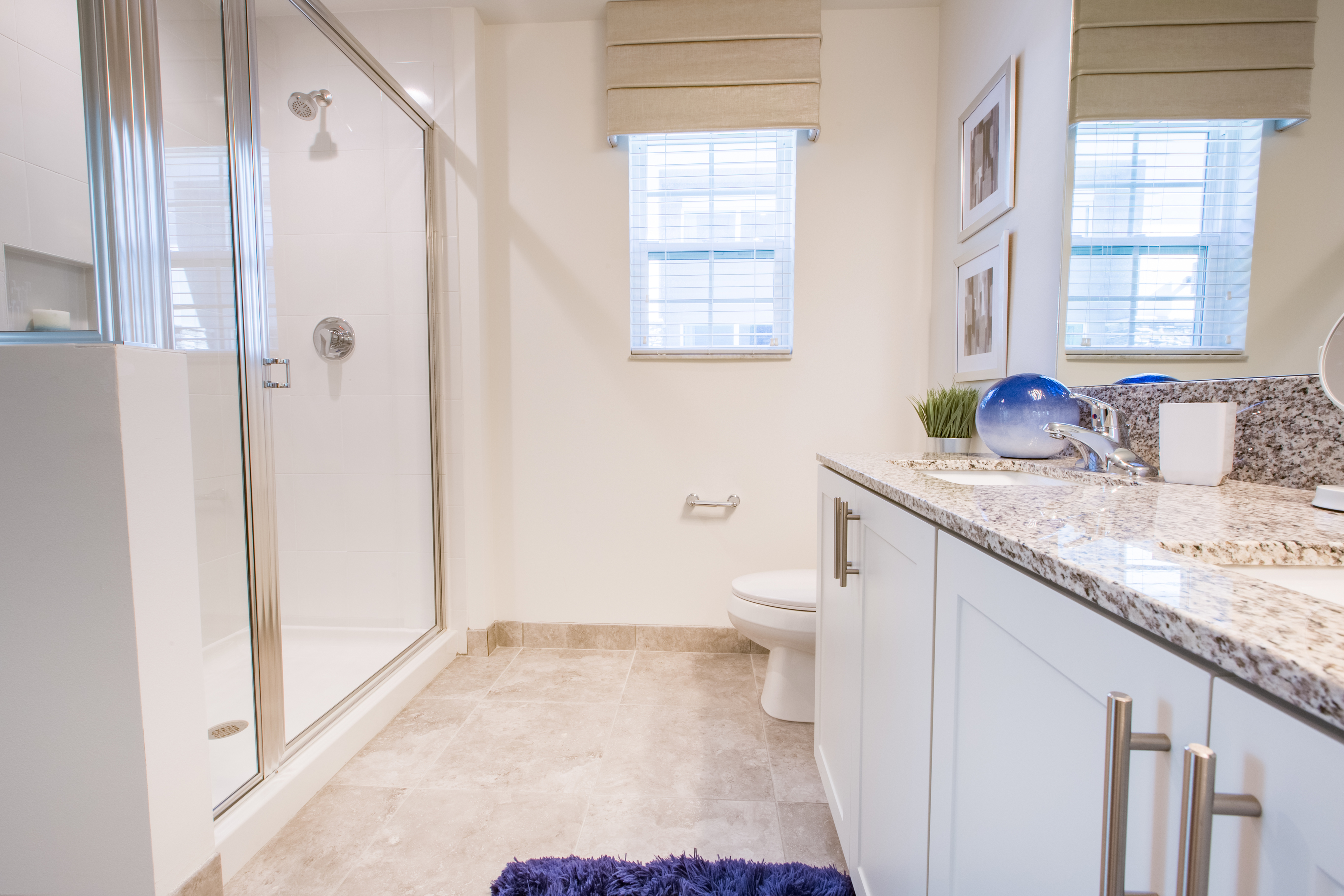 View of Bathroom, Showing Walk-In Shower, Granite Countertop, and Double Sinks at Cottonwood West Palm Apartments