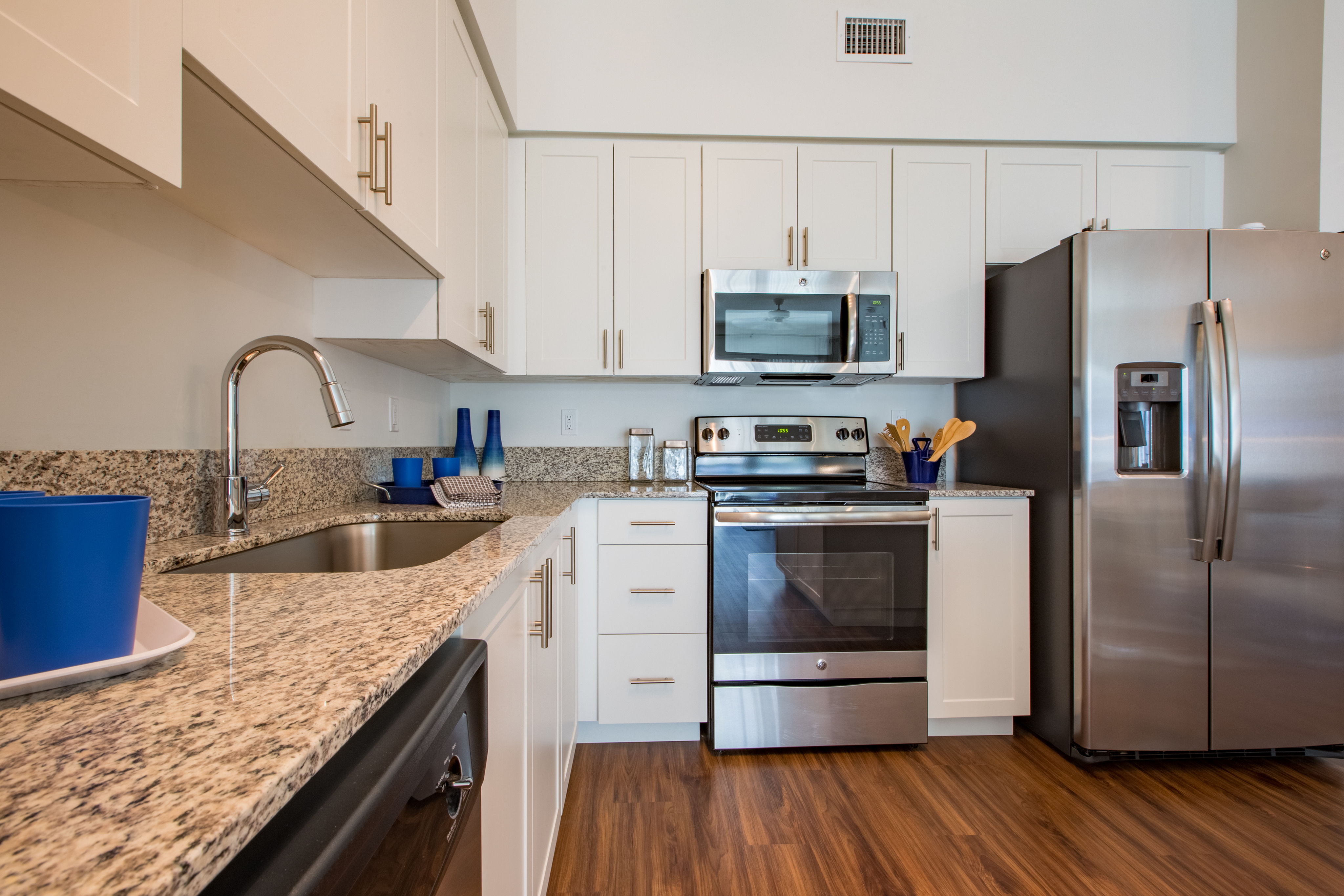 Enjoy Our Gourmet Kitchen, With View of Island, Granite Countertop, and Stainless Steel Appliances at Cottonwood West Palm Apartments