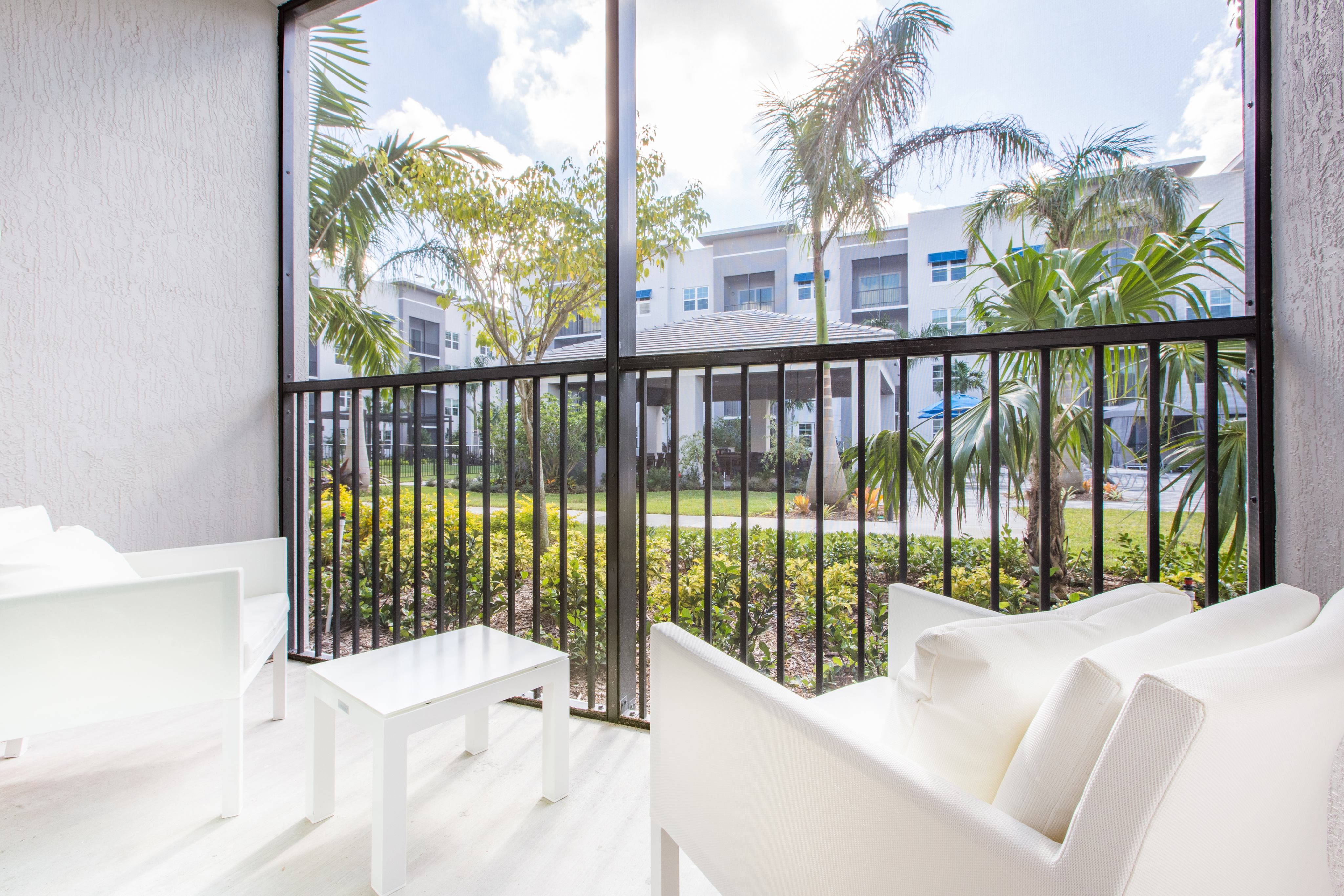 View of Patio, Showing Screened-In Patio with View of Outside at Cottonwood West Palm Apartments