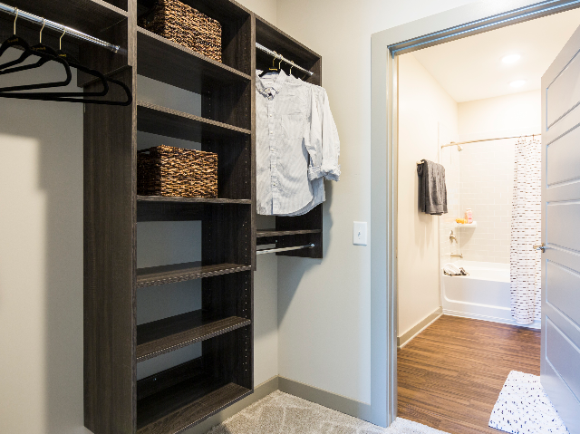 Enjoy Our Walk-In Closet, With View of Storage Space, Hangers, and Bin at Alton Optimist Park Apartments