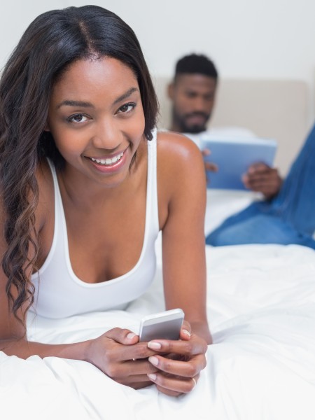 Residents Relaxing in the Master Bedroom | Baltimore Apartment | Greens at Forest Park