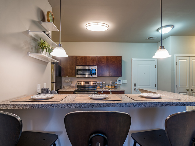 Spacious kitchen featuring stainless steel and black appliances