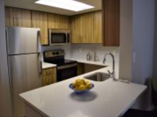 Newly Renovated Kitchen With Quartz Counter Tops, Tile Backsplash, Wood-Style Flooring and Stainless Steel Appliances