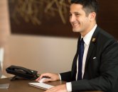 Male professional seated at desk l Monterey Pointe Apartments