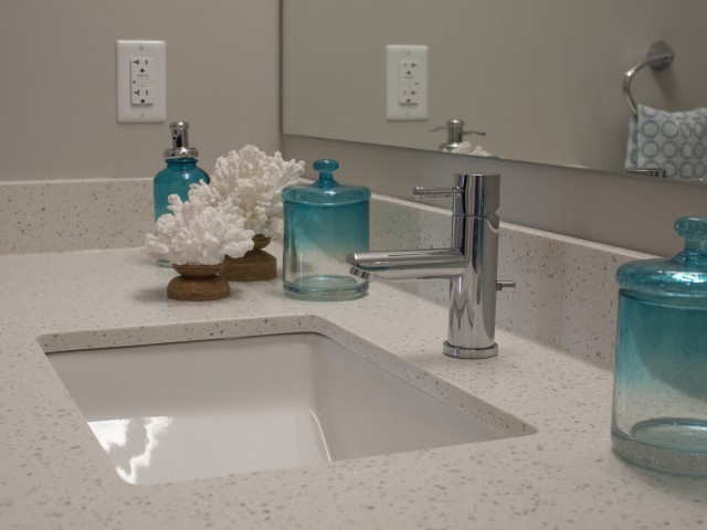 Image of Elegant bathrooms with ceramic tile flooring, quartz countertops, spacious cabinets and ceramic tile tub and shower surround for 500 Park Avenue