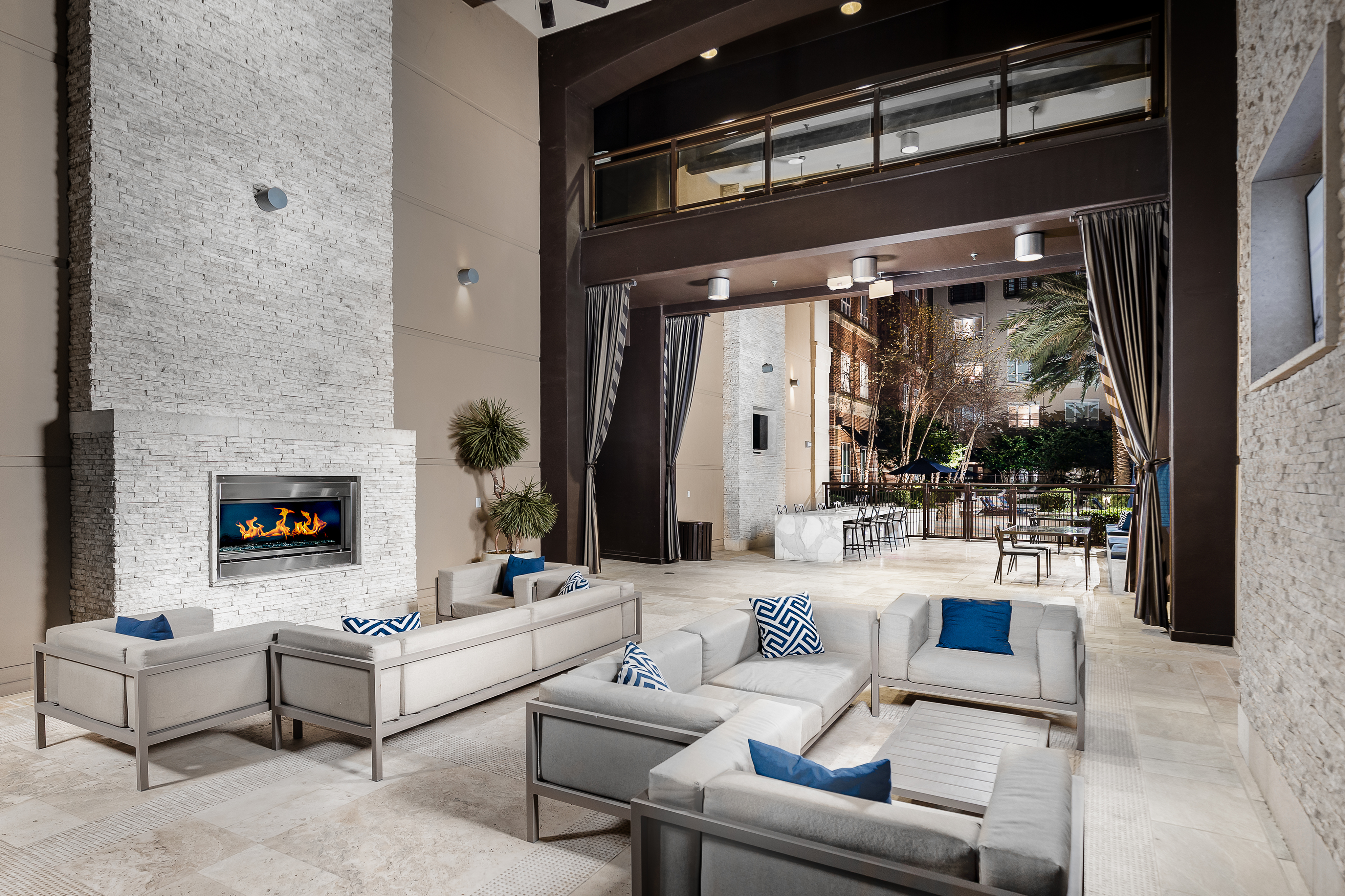 Open-air Loggia with fireplace and HDTV lounge